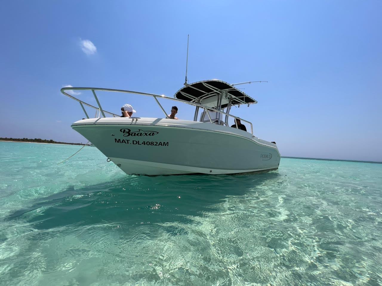 Private boat with children exploring the Starfish Sanctuary in Cozumel